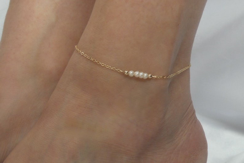 golden anklet with white pearl