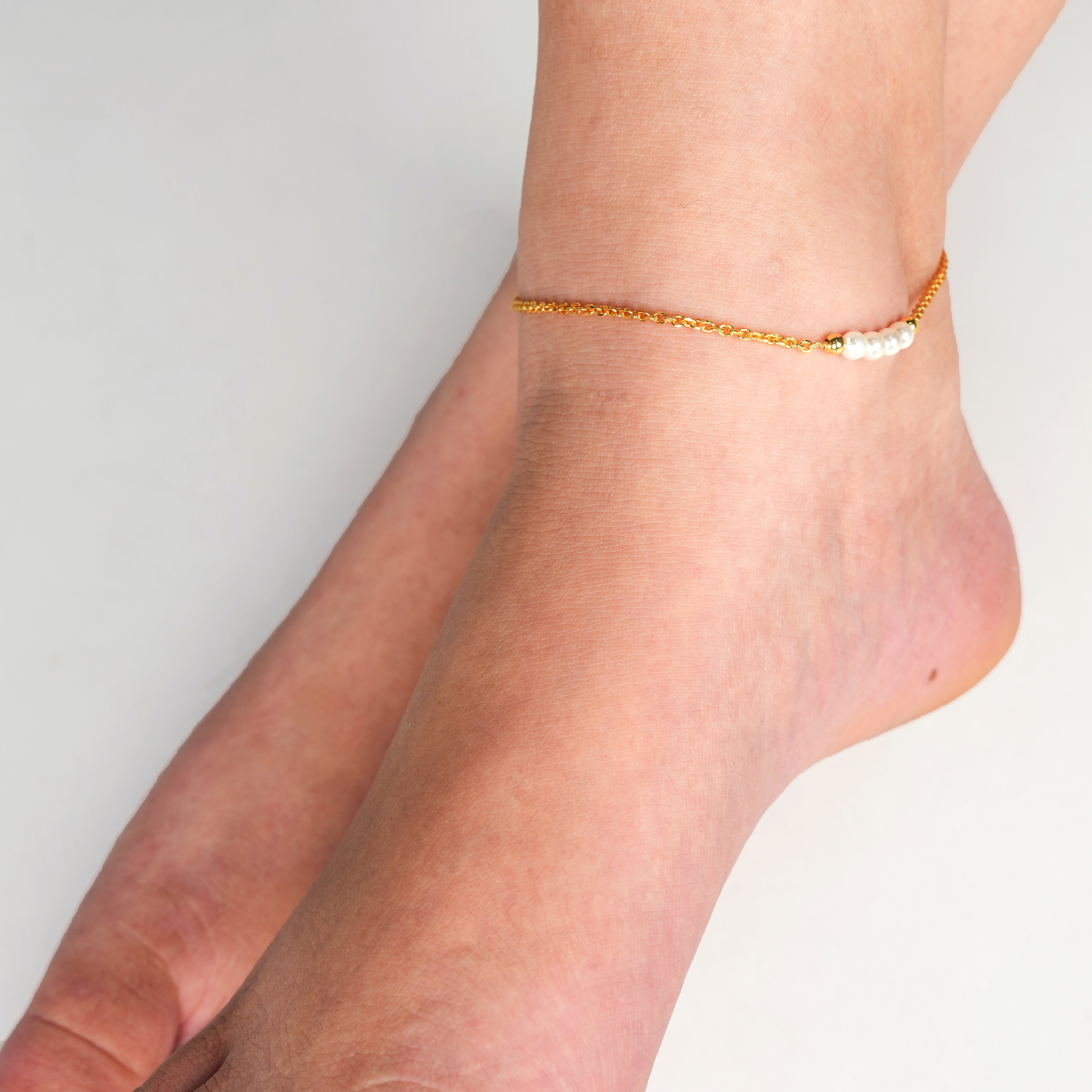 Delicate gold chain anklet with white pearl accents