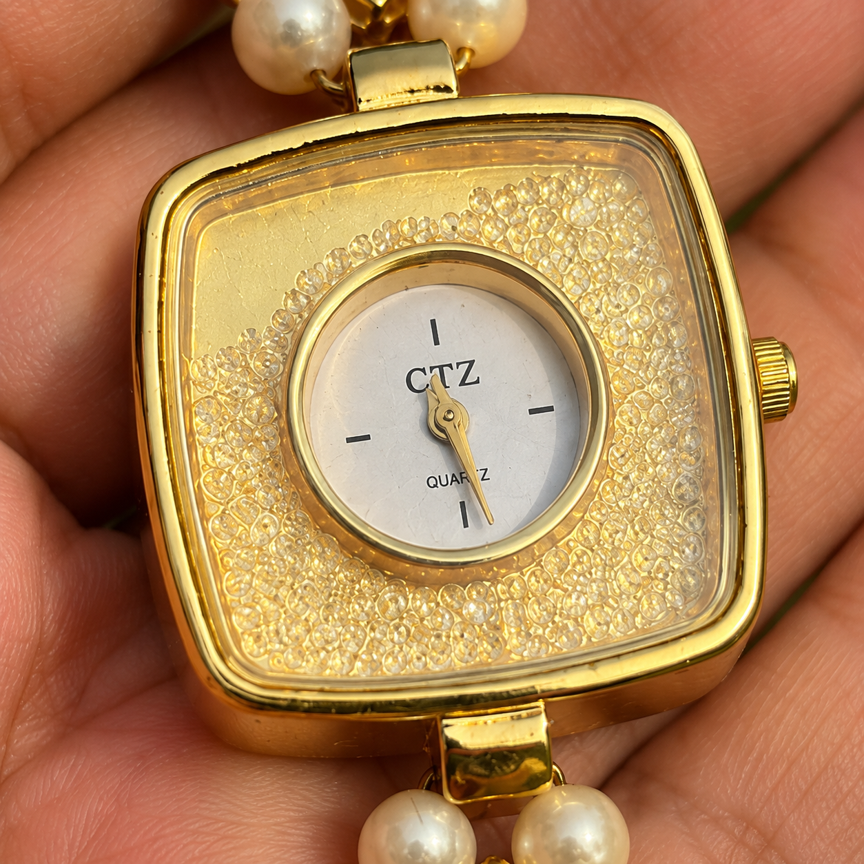 gold textured dial watch